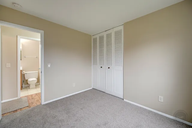 a view of an empty room and bathroom