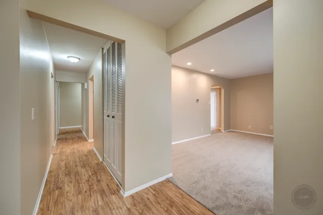 a view of a hallway with wooden floor