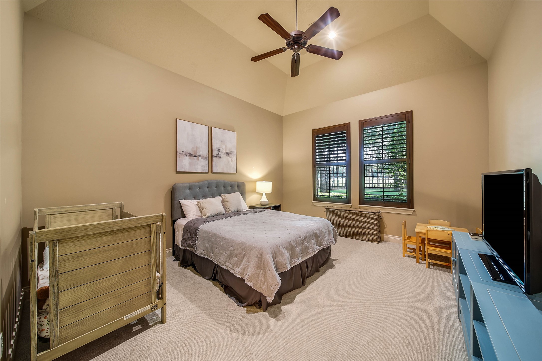 852 Eagle Pointe Montgomery, TX 77316 - Photo 26 of 48 a spacious bedroom with a bed and a flat screen tv