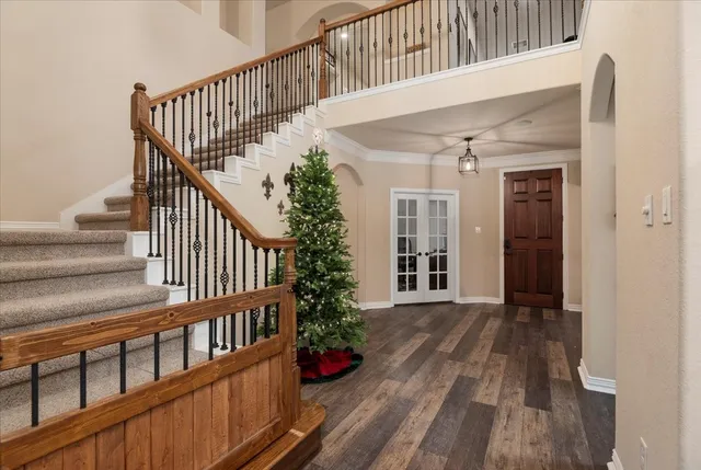 a view of staircase with wooden floor and a potted plant