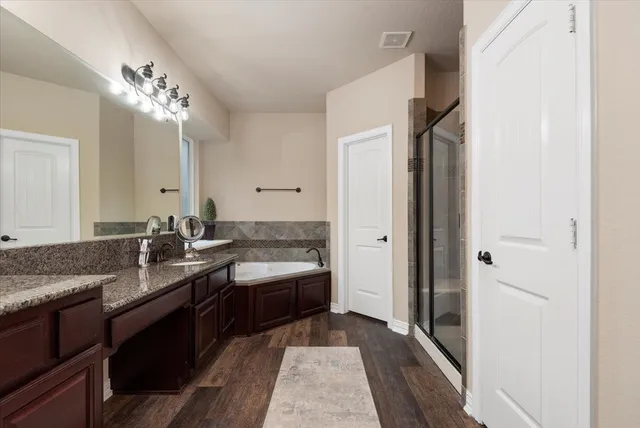 a bathroom with a granite countertop sink a mirror and a vanity