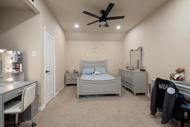 a spacious bedroom with a bed and a chandelier