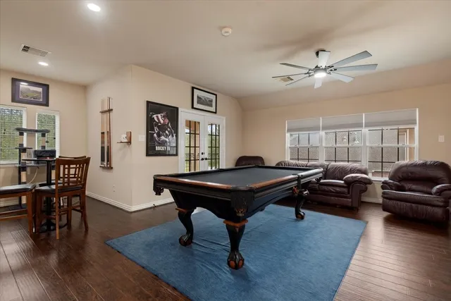 a living room with furniture a dining table and wooden floor