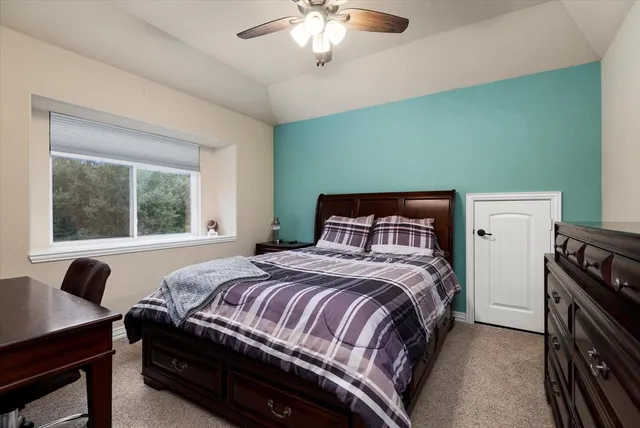 a bedroom with a bed and a window