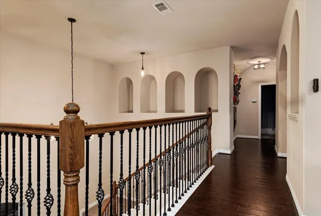 a view of a hallway with wooden floor