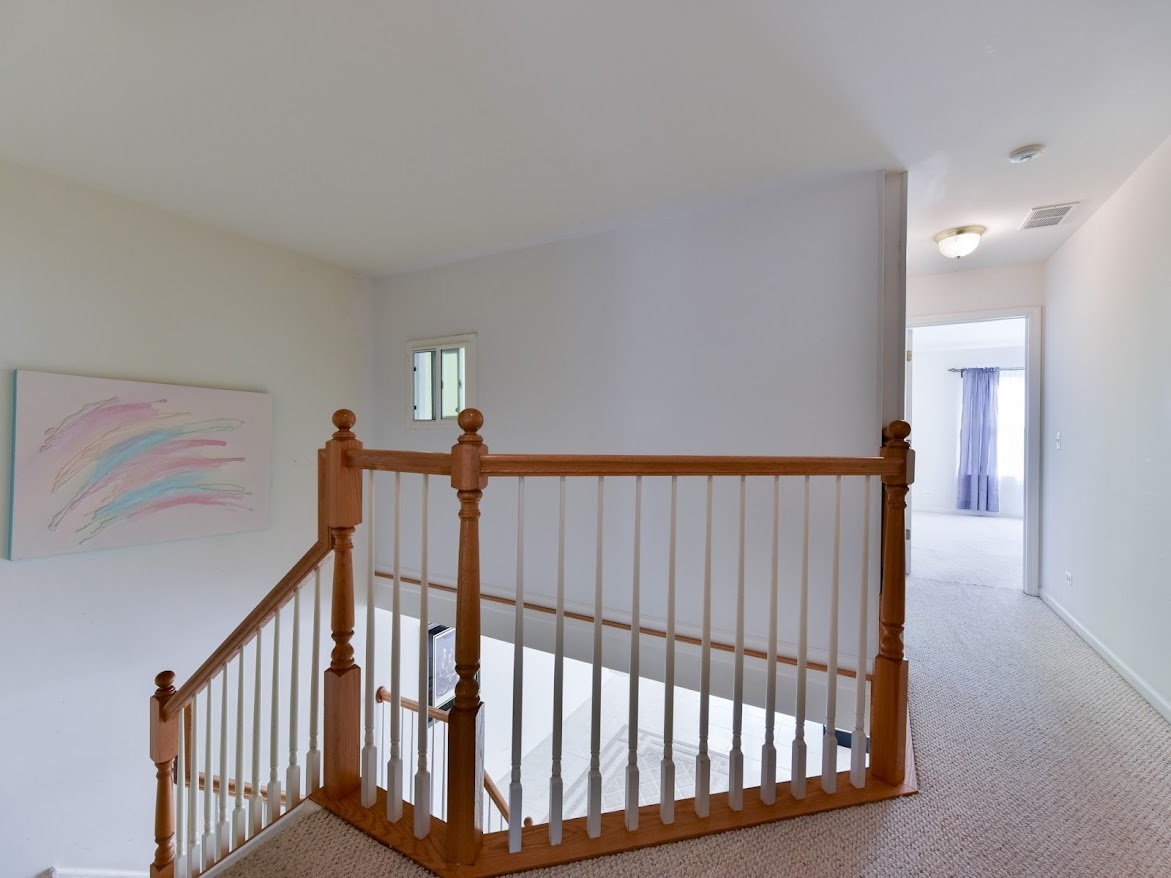 3110 Crystal Rock Road Naperville, IL 60564 - Photo 15 of 27 a view of staircase with railing and a rug