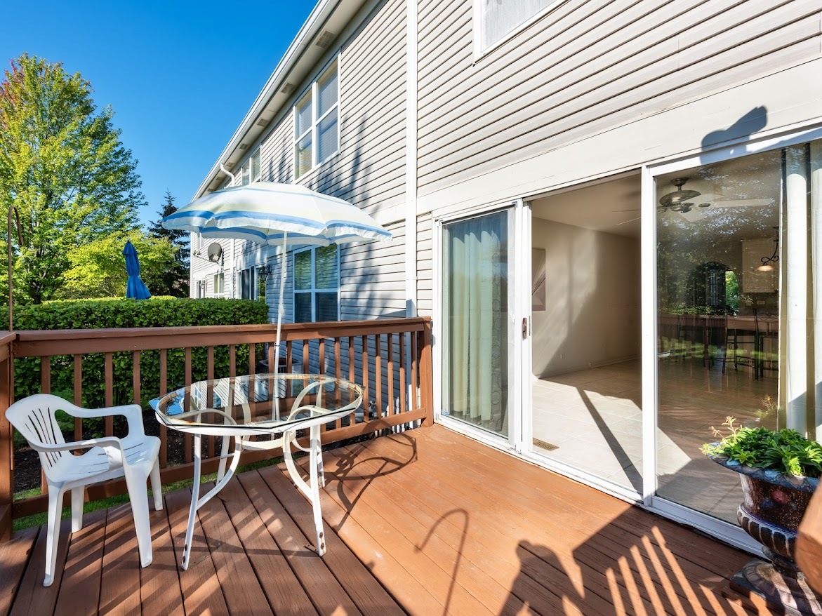 3110 Crystal Rock Road Naperville, IL 60564 - Photo 23 of 27 a view of a patio with a table chairs and wooden floor