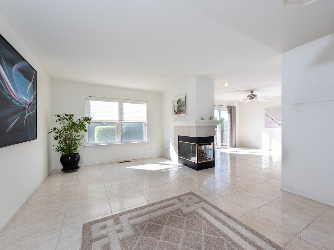 3110 Crystal Rock Road Naperville, IL 60564 - Photo 6 of 27 a view of an empty room with a fireplace and a window