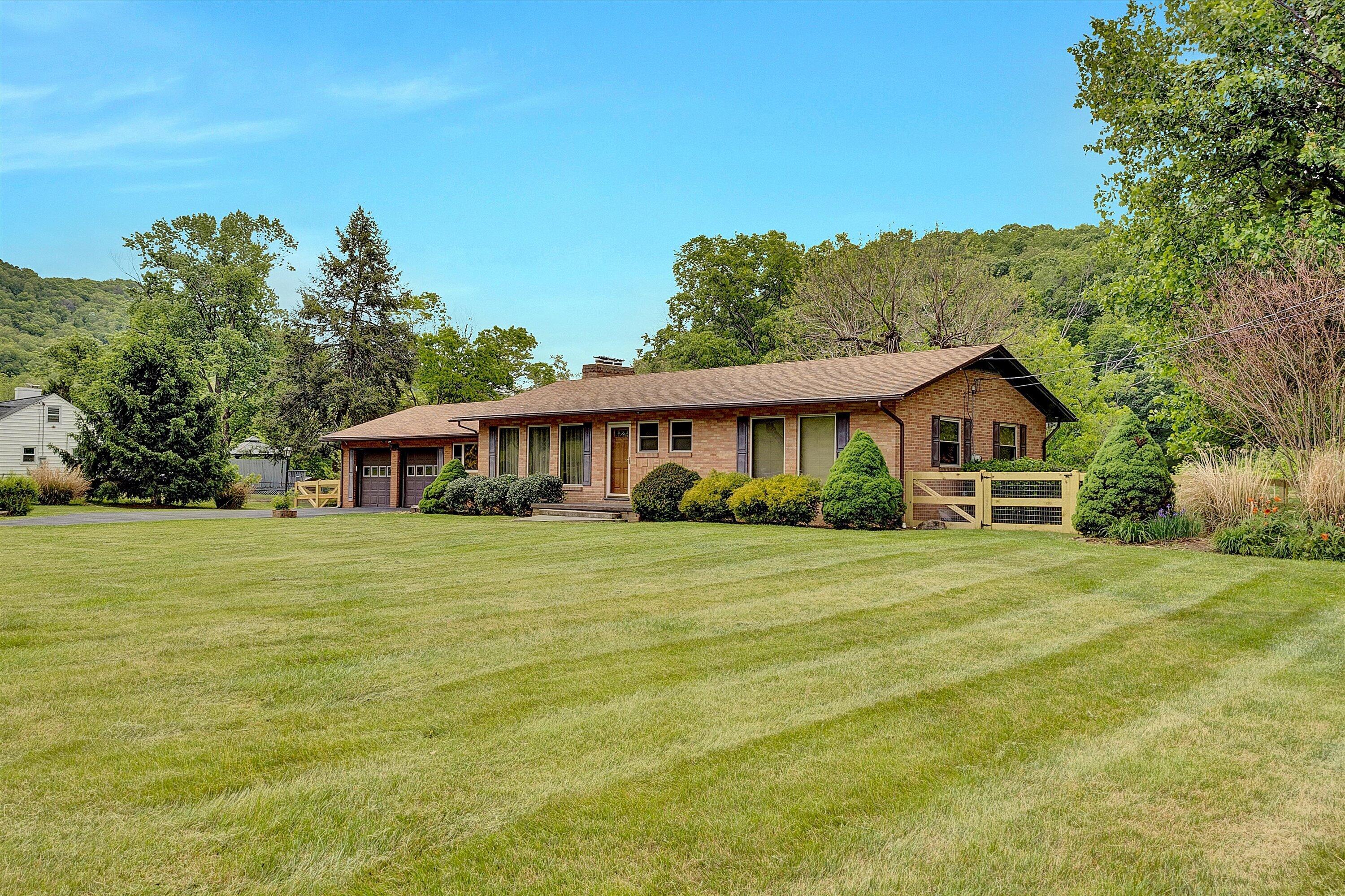 2015 Evergreen Road Covington, VA 24426 - Photo 3 of 46 a front view of a house with a garden