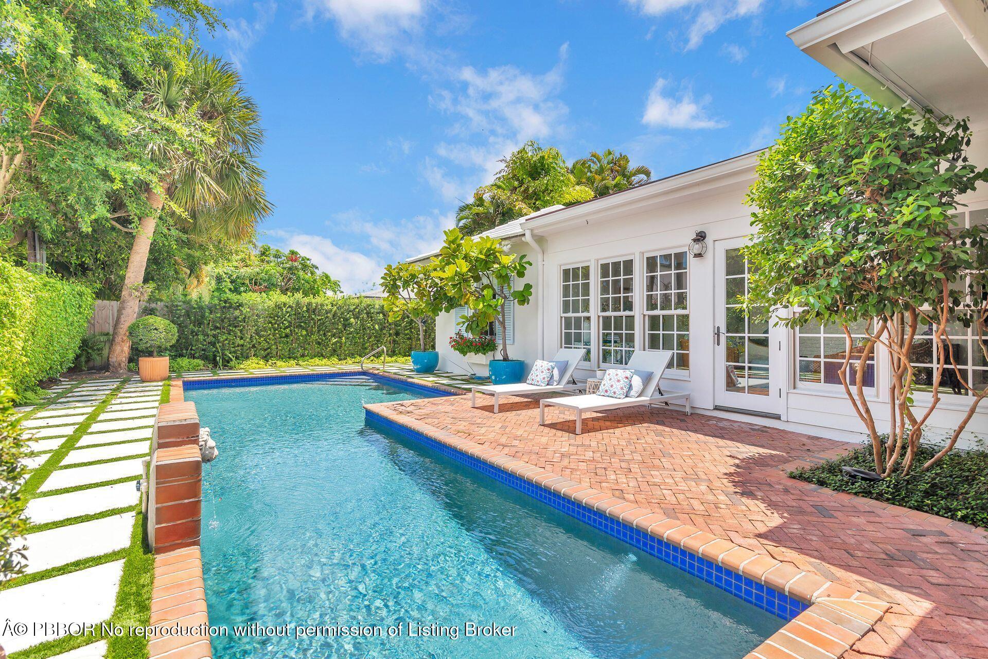 255 Colonial Lane Palm Beach, FL 33480 - Photo 23 of 32 a view of house with yard and swimming pool