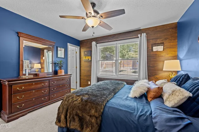 a bedroom with a large bed and a large mirror