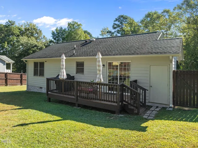 a view of a house with a yard and furniture