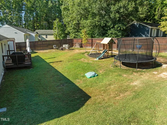 an aerial view of a house with swimming pool garden and patio
