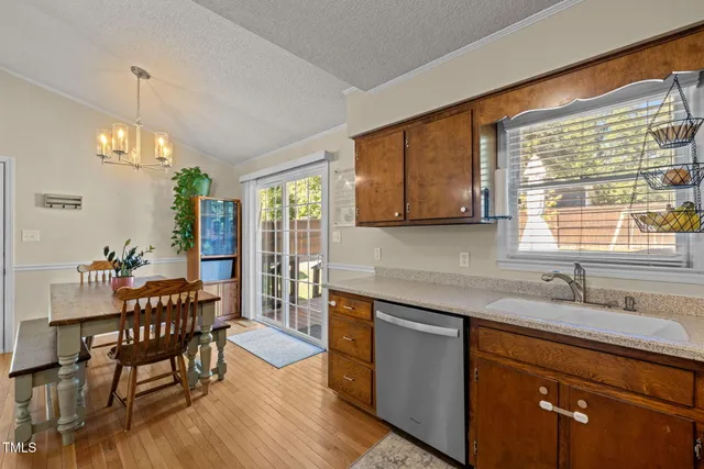 a kitchen with stainless steel appliances granite countertop sink stove top oven and cabinets