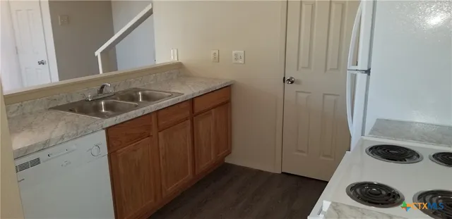 a kitchen with a sink and a stove top oven
