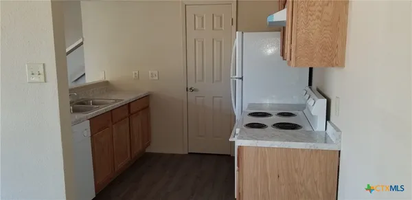 a kitchen with a stove and a refrigerator