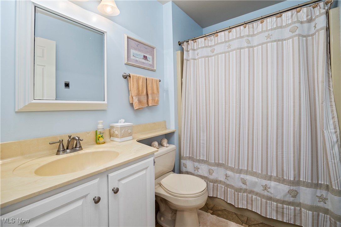 1507 Cleveland Road East, Unit 435 Huron, OH 44839 - Photo 24 of 37 Bathroom featuring tile patterned flooring, vanity, toilet, and a shower with curtain