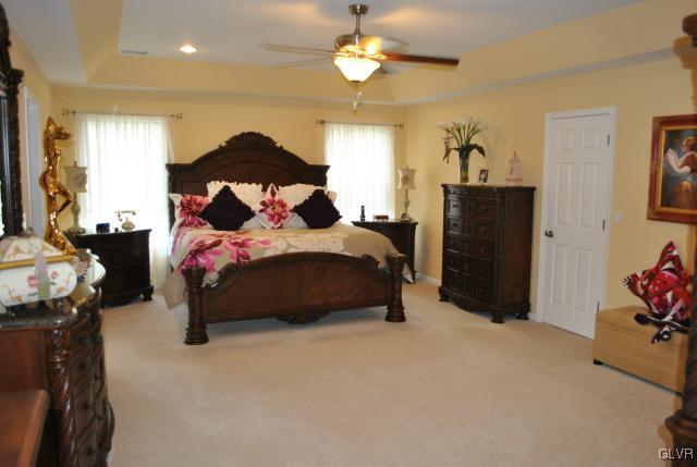 109 Fox Ridge Nazareth, PA 18064 - Photo 20 of 33 a bedroom with bed and a chandelier