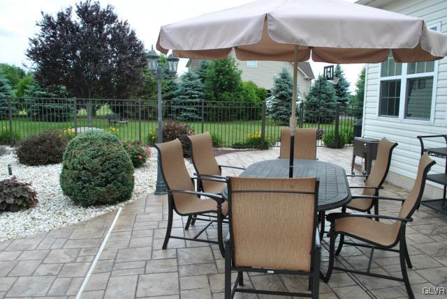 109 Fox Ridge Nazareth, PA 18064 - Photo 28 of 33 a patio table and chairs with potted plants and a yard