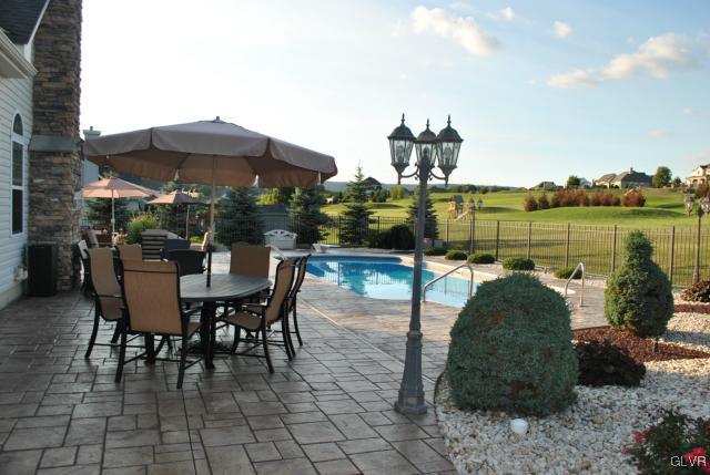 109 Fox Ridge Nazareth, PA 18064 - Photo 30 of 33 a view of a lake with a table and chairs under an umbrella