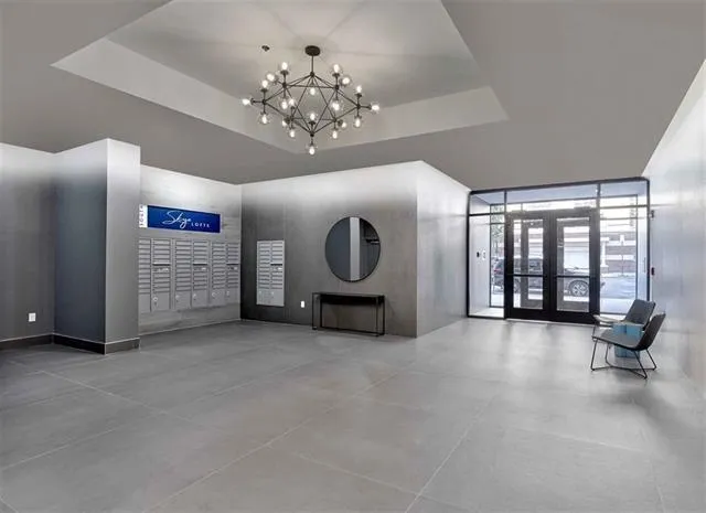 a living room with a couch and a lamp