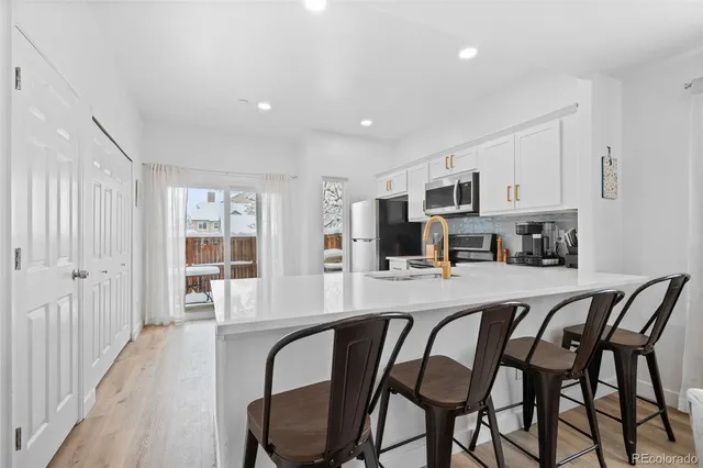 a dining room with furniture and a kitchen view