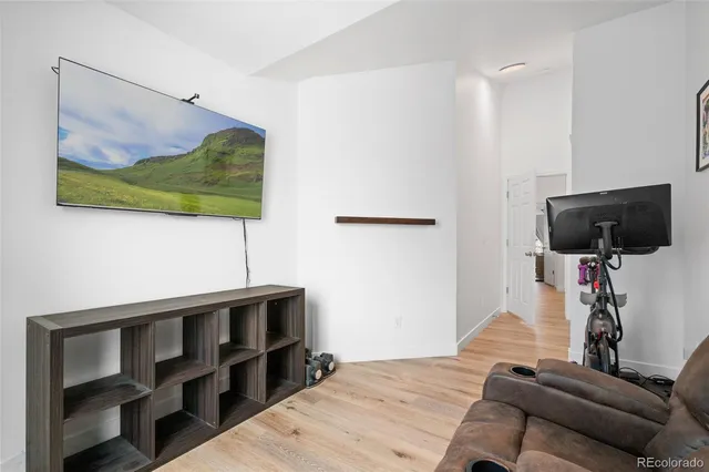 a bedroom with a bed window and flat screen tv