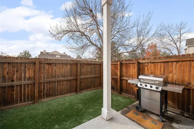 a view of a backyard with wooden fence