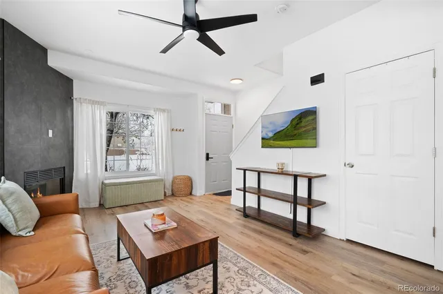 a living room with furniture and a wooden floor