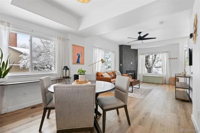a living room with furniture a wooden floor and a large window