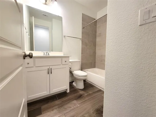 a bathroom with a toilet a sink and a mirror