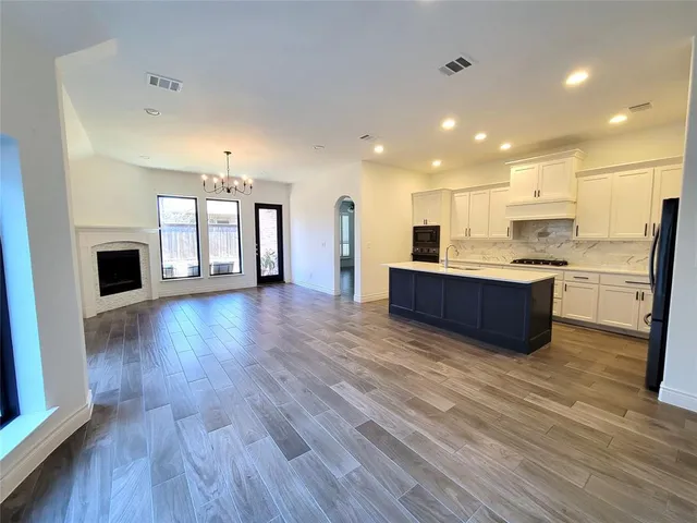 a view of kitchen with cabinets and wooden floor