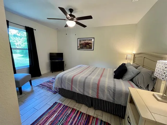 a bedroom with a bed and a window