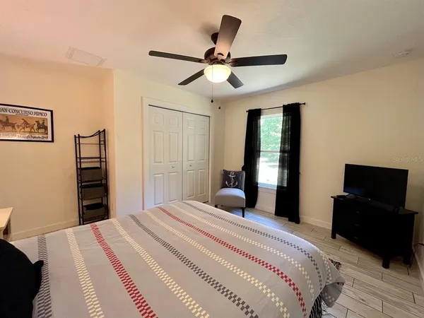 a bedroom with a bed and a flat screen tv