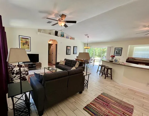 a living room with furniture a fireplace and a window