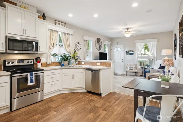 a kitchen with a sink stove and microwave