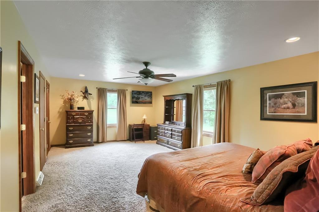 135 Staff Road Slippery Rock, PA 16057 - Photo 17 of 25 a bedroom with a large bed a flat tv screen and dresser