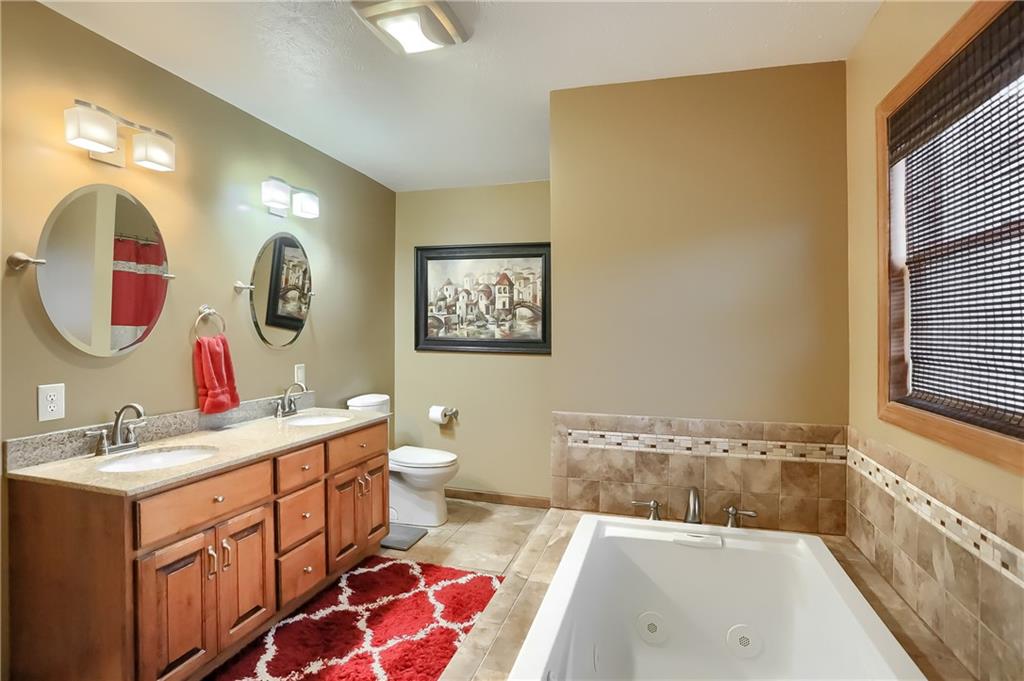 135 Staff Road Slippery Rock, PA 16057 - Photo 21 of 25 a spacious bathroom with a sink mirror and a bathtub