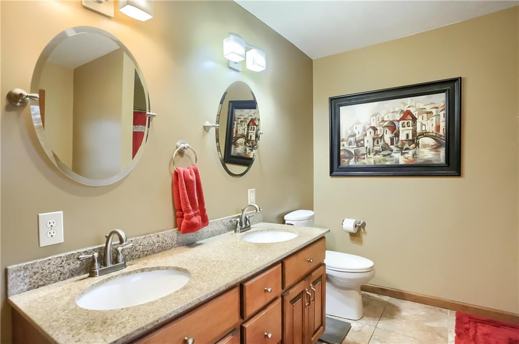 135 Staff Road Slippery Rock, PA 16057 - Photo 22 of 25 a bathroom with a toilet a sink and a mirror