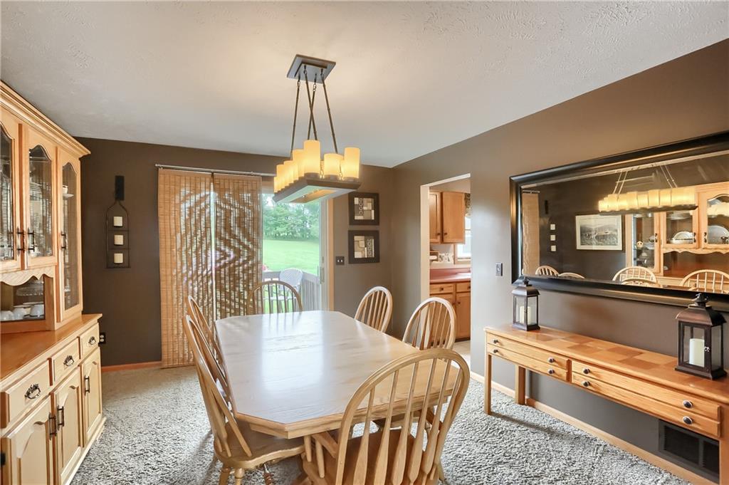 135 Staff Road Slippery Rock, PA 16057 - Photo 7 of 25 a view of a dining room and livingroom with furniture wooden floor a chandelier