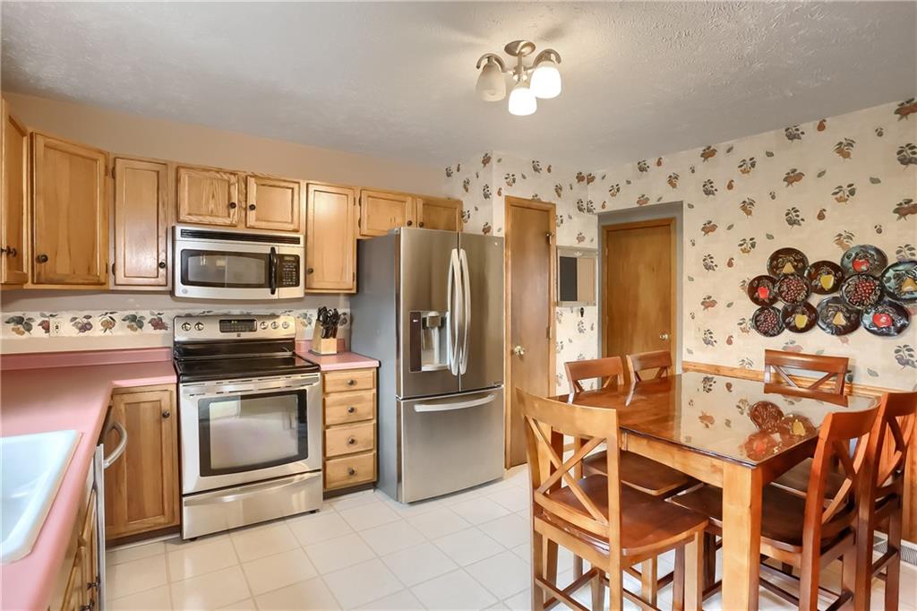 135 Staff Road Slippery Rock, PA 16057 - Photo 9 of 25 a kitchen with stainless steel appliances granite countertop a refrigerator and a stove top oven