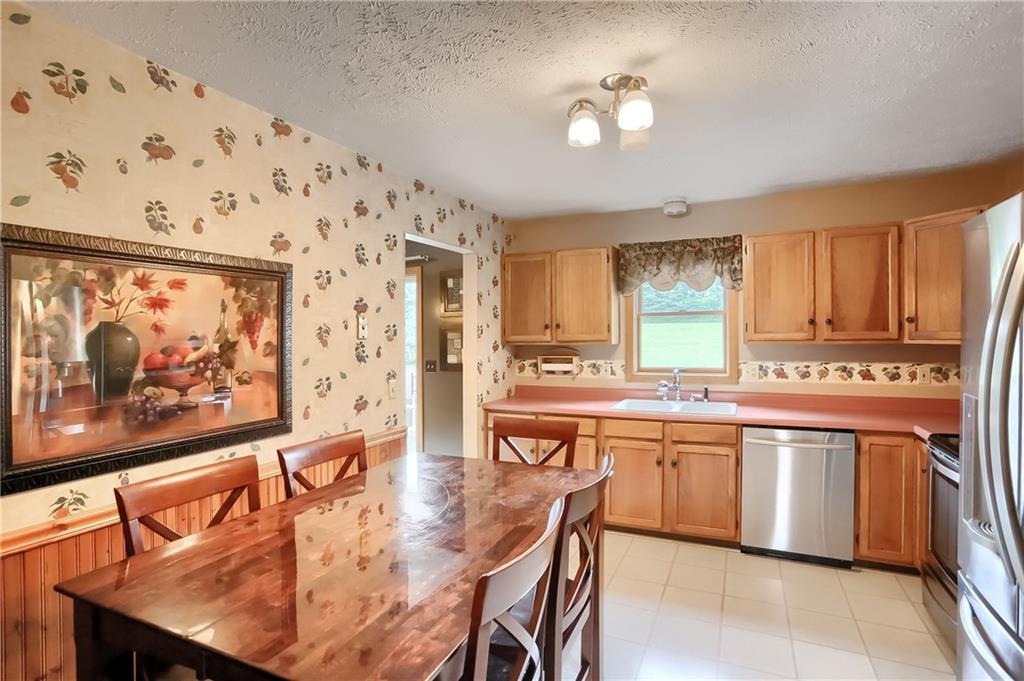 135 Staff Road Slippery Rock, PA 16057 - Photo 10 of 25 a kitchen with stainless steel appliances granite countertop a stove a sink and a refrigerator