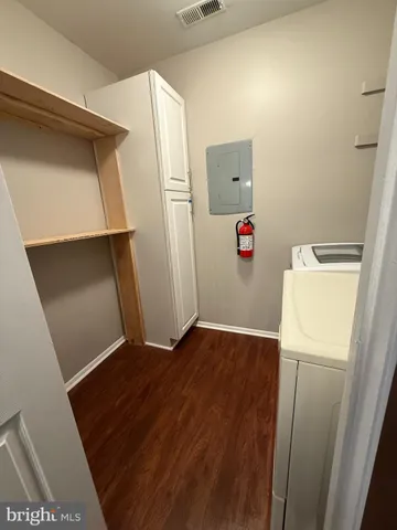 a view of storage and utility room with refrigerator