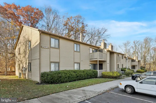 a car parked in front of a white house