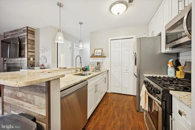 a kitchen with stainless steel appliances granite countertop a stove and a sink