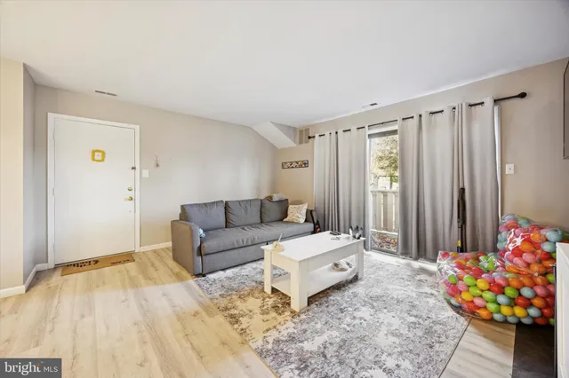 a living room with furniture and flowers