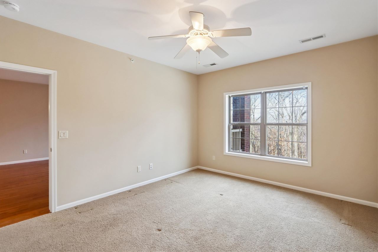 856 Foster Road Iowa City, IA 52245 - Photo 17 of 39 Primary bedroom with view to woods
