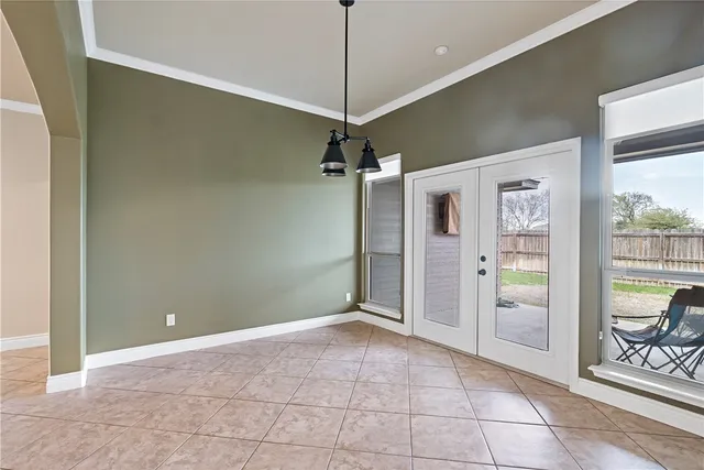 a bedroom with a balcony a bed and a window