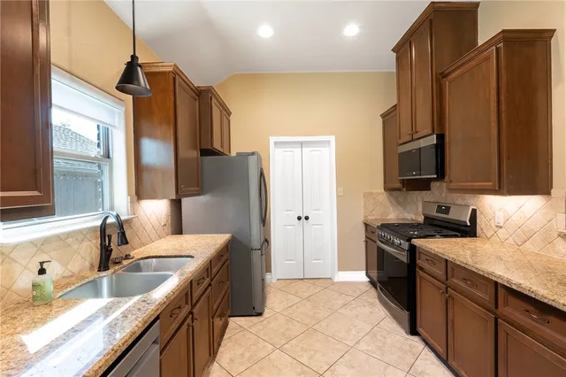 a bedroom with a large bed and a potted plant