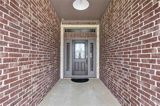 a view of a hallway with wooden floor and stairs